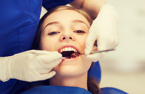 Children's Dentist in the middle of a check up in Ballard WA