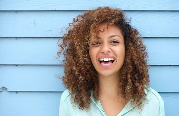 Woman smiling after visiting the Dentist in Seattle, WA